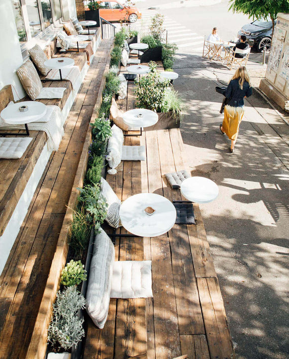 Oil finished wood boards make up steps and seats on patio at and avocado bar.