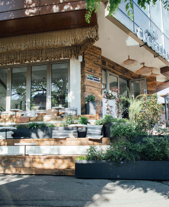 Restaurant exterior with wooden stepped dining patio